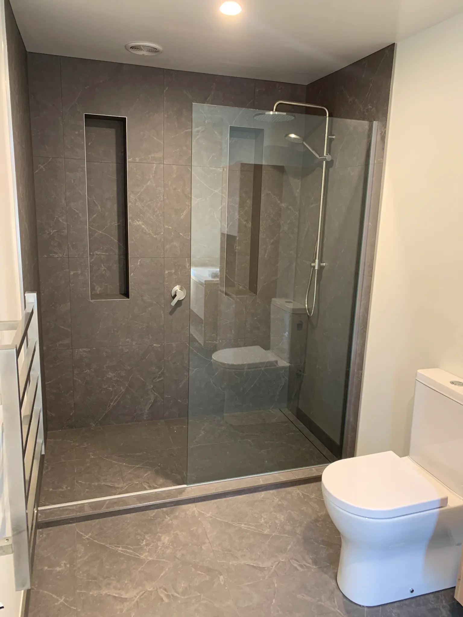 Completed Christchurch bathroom with a walk-in shower, tiled surrounds and glass screen